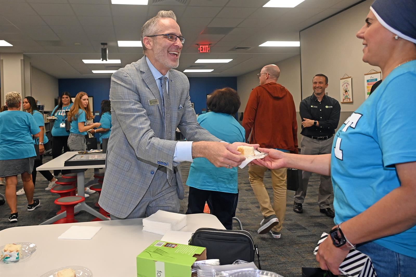Cameron Dickey, Cy-Fair Federal Credit Union president and CEO, serves cake to Fiest Elementary School staff.